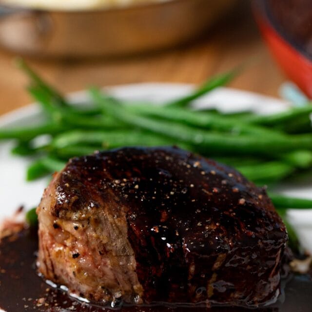 Filet with Red Wine Reduction on plate with green beans