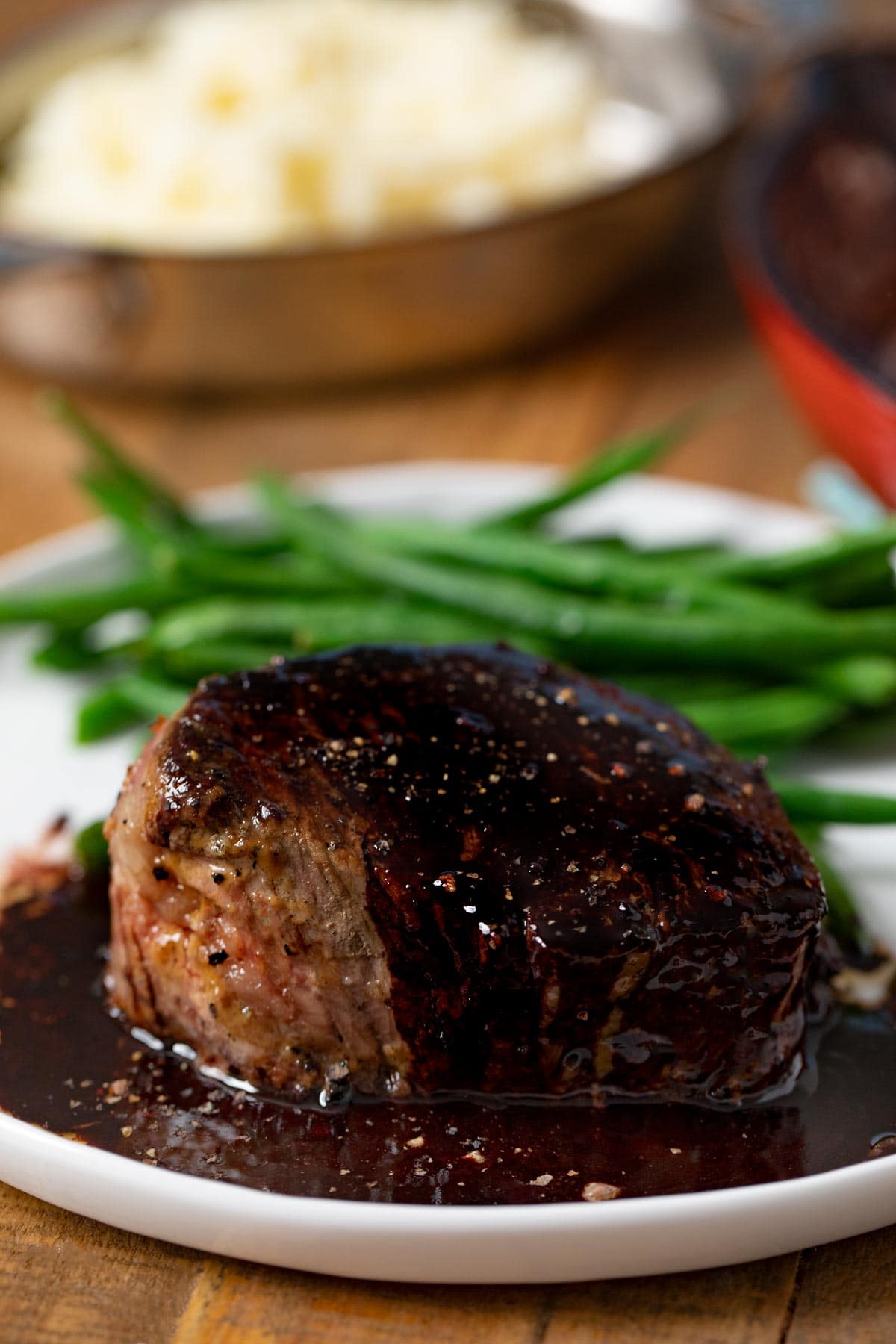 Filet with Red Wine Reduction on plate with green beans