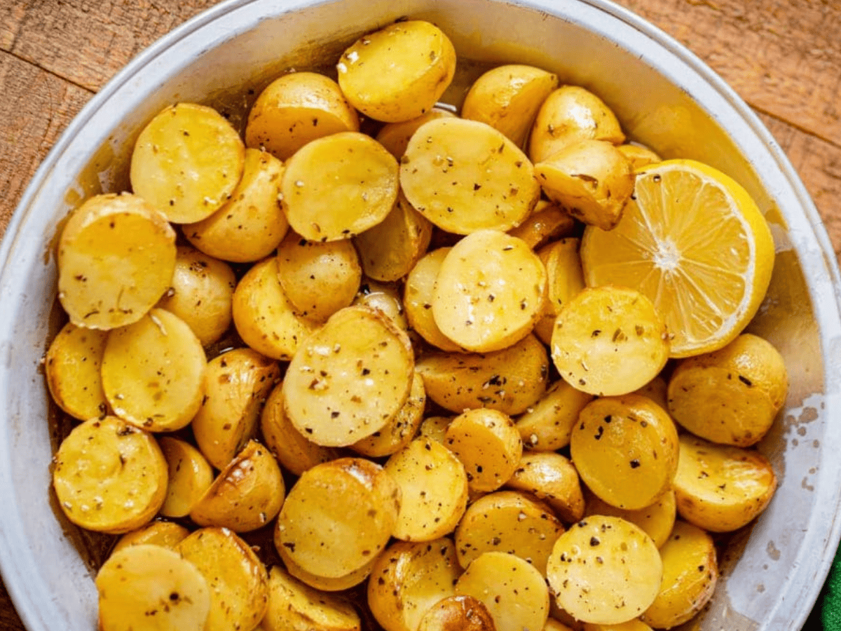 cut potatoes in mixing bowl with lemon wedge