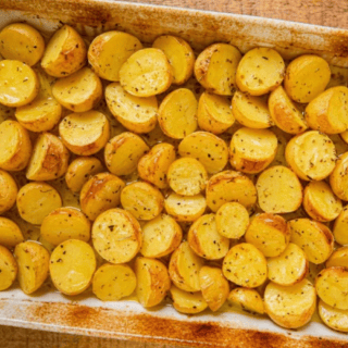 cooked potatoes in baking dish with seasoning