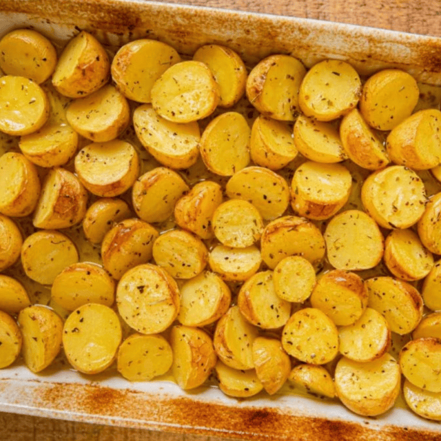 cooked potatoes in baking dish with seasoning