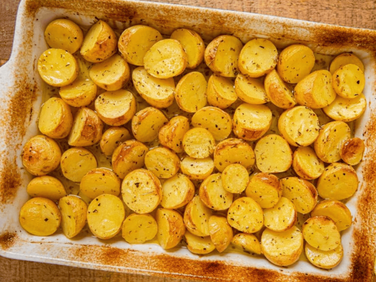 cooked potatoes in baking dish with seasoning