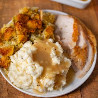 Make-Ahead Turkey Gravy served over mashed potatoes on plate