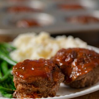 Meatloaf Muffins on plate with mashed potatoes and green beans