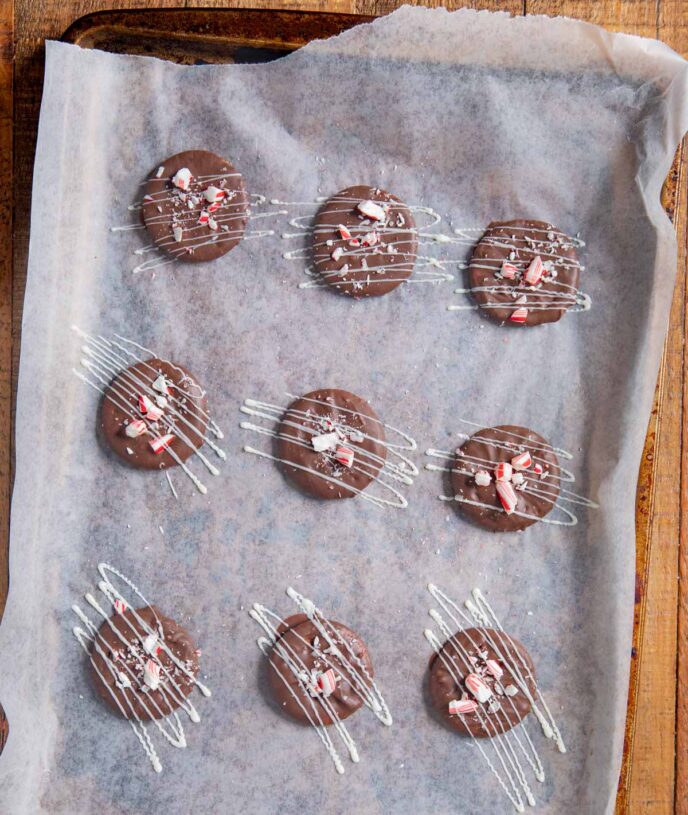 Peppermint Bark Crackers on baking pan with white chocolate drizzle