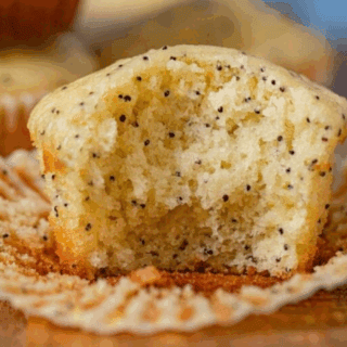 Muffin with paper open and bite taken out