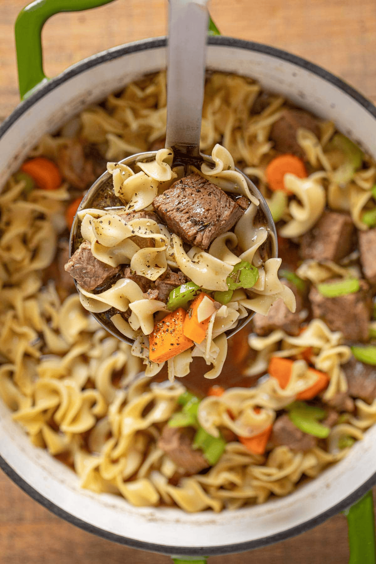 Ladling noodle and beef soup