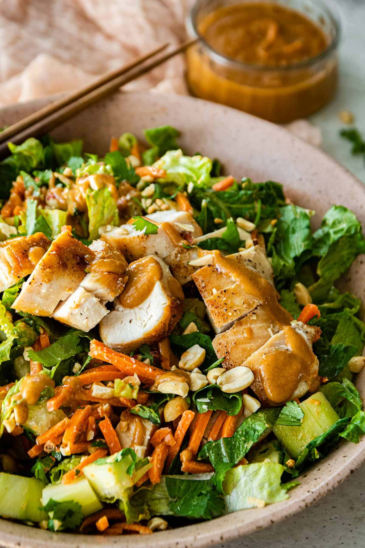 Asian Chicken Salad with Sesame Peanut Dressing in serving bowl
