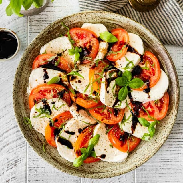 Caprese Salad with Balsamic Reduction on serving plate 1x1