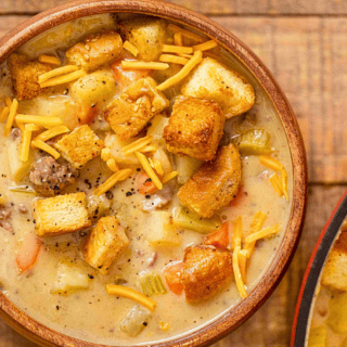 ground beef, croutons, veggies, and shredded dairy in bowl