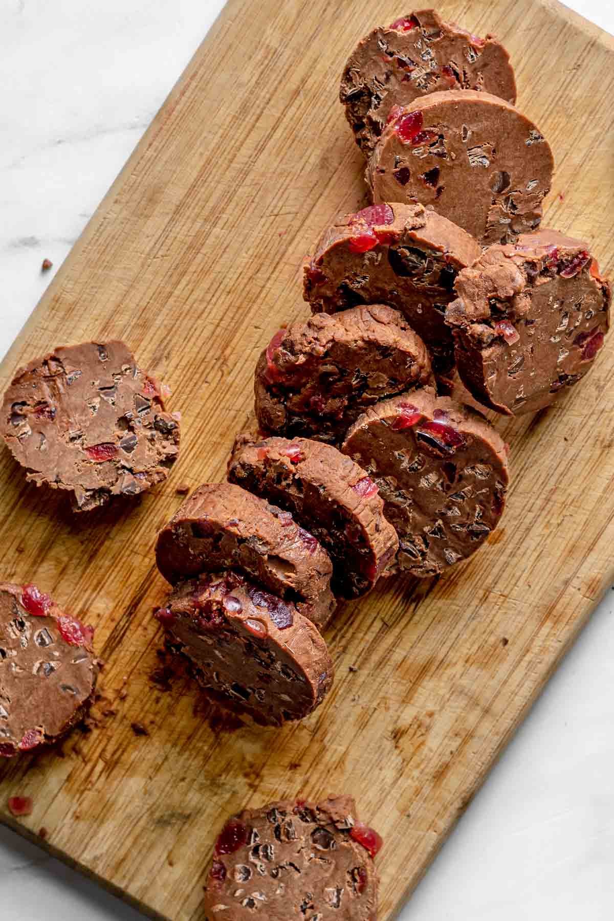 Cherry Chocolate Shortbread Cookies dough sliced on cutting board