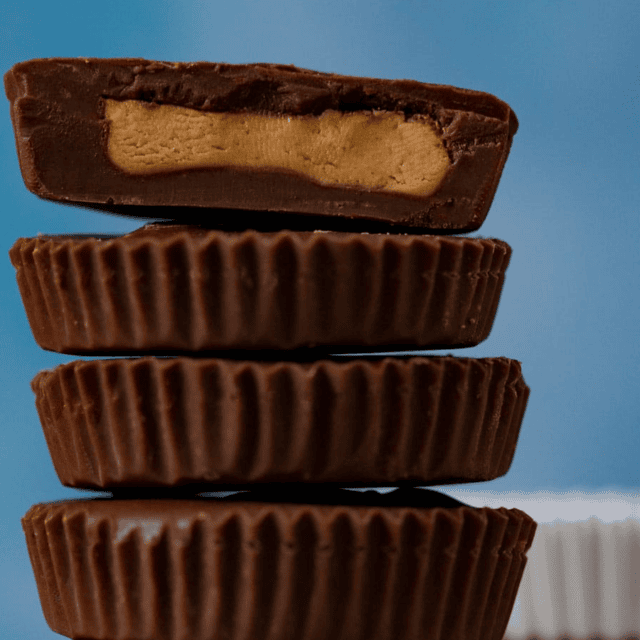 Brownish candy in stack with the top one cut in half