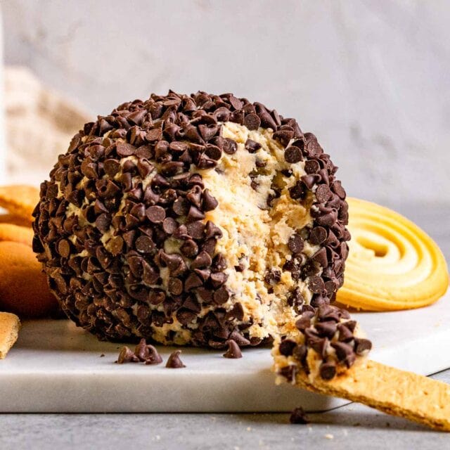 Cookie Dough Cheese Ball on serving dish with graham cracker