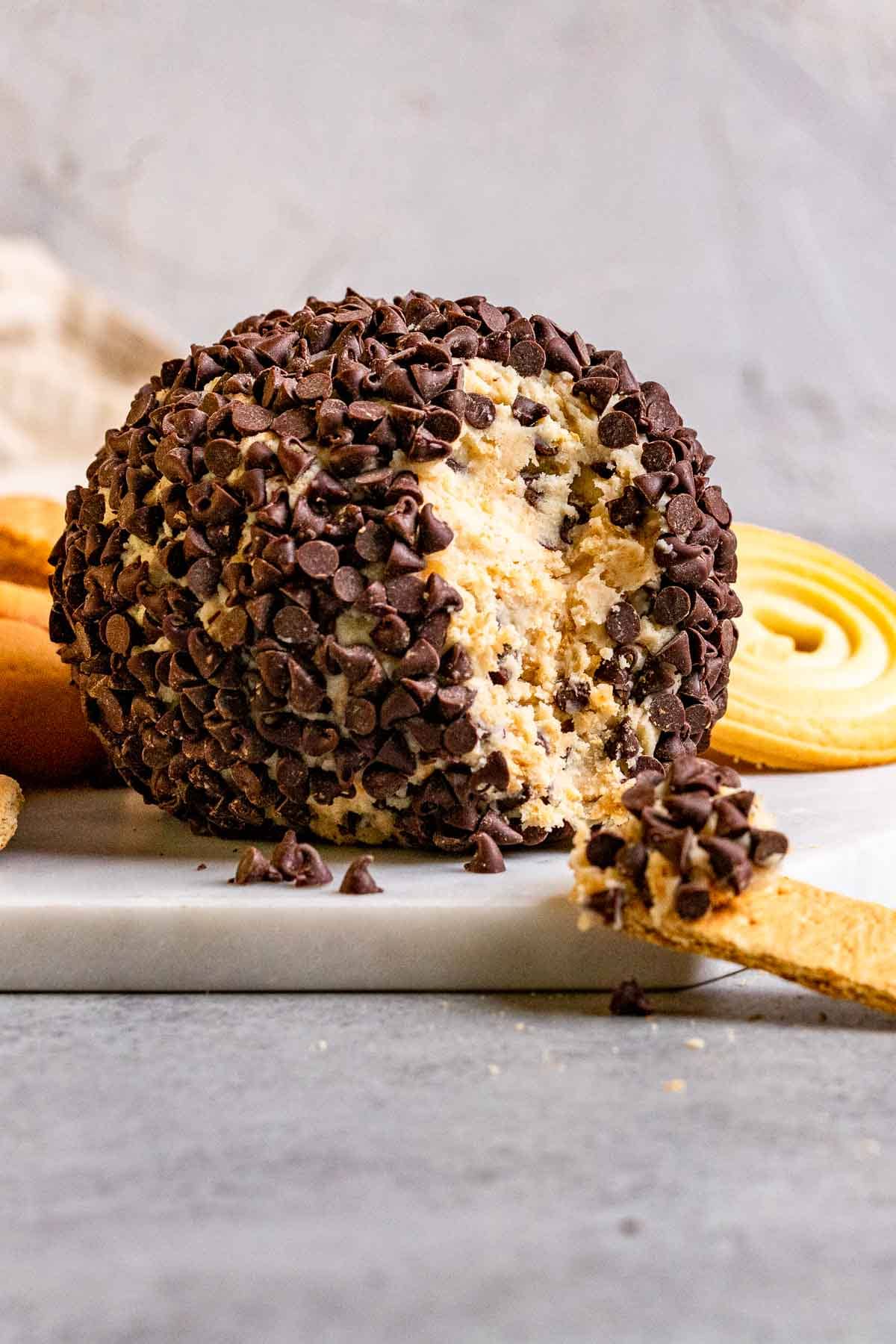 Cookie Dough Cheese Ball on serving dish with graham cracker