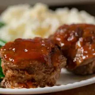 Two mini meatloaves with sauce on a plate