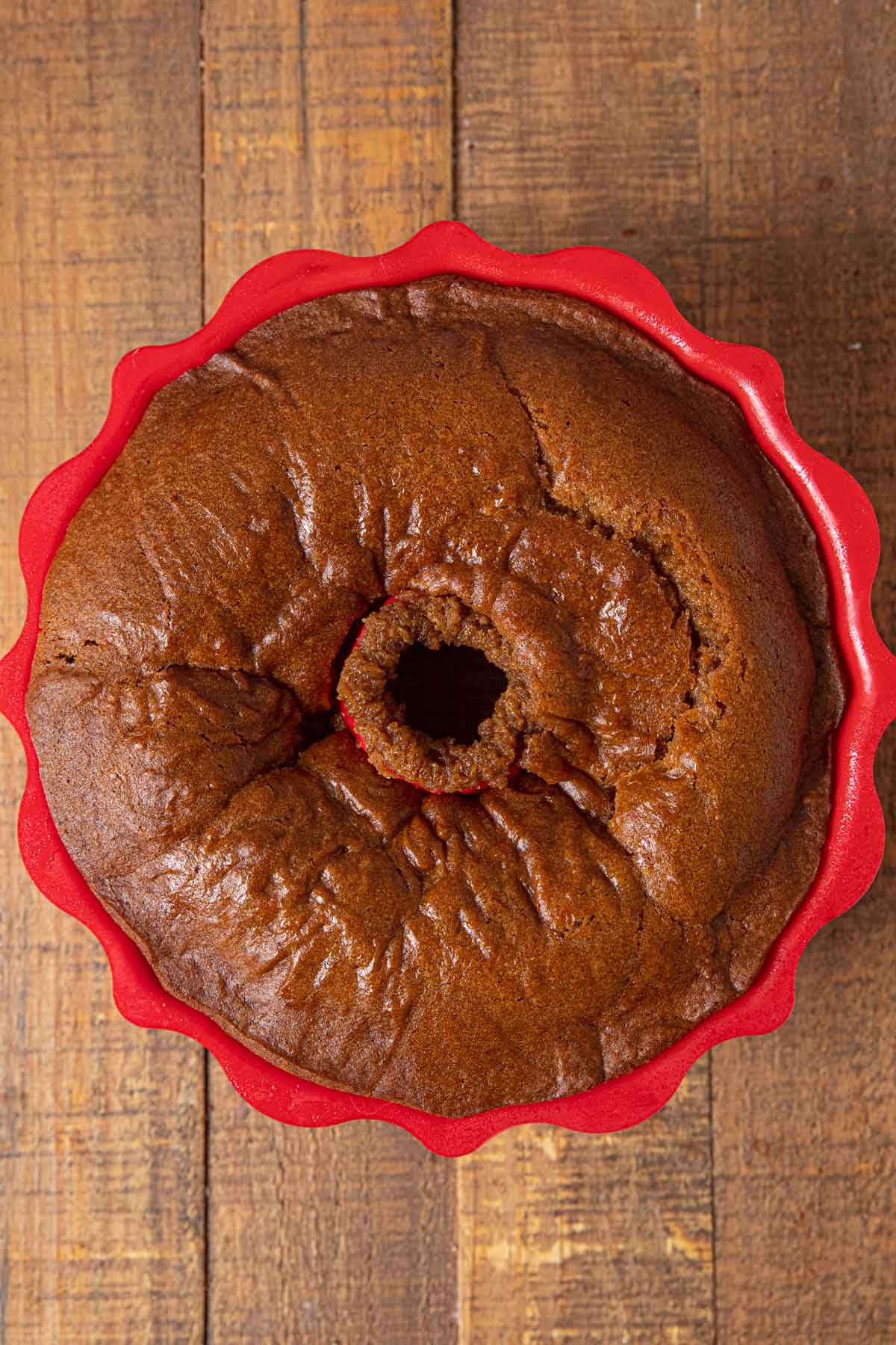 Pumpkin Bundt Cake baked in red silicone bundt cake pan