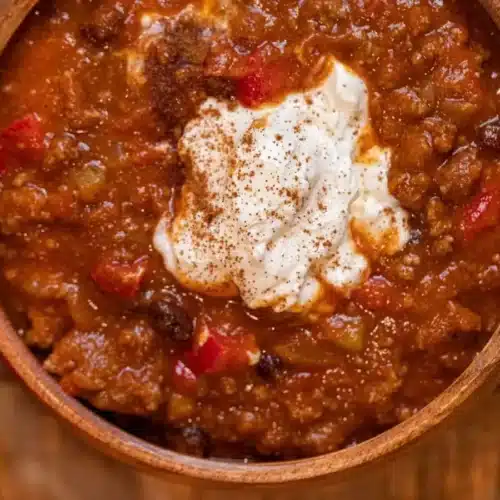 bowl of chili topped with sour cream