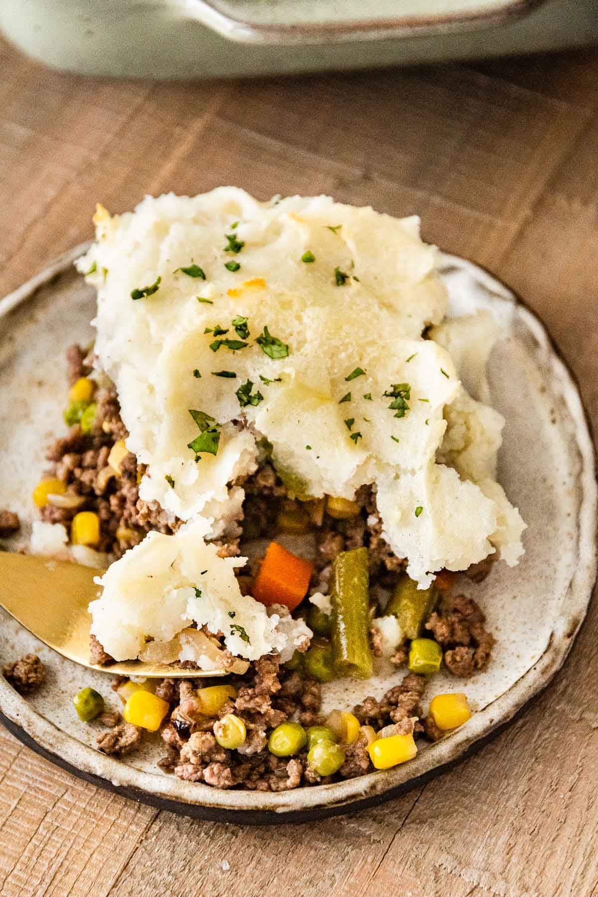 Beef Shepherd's Pie slice on plate with fork