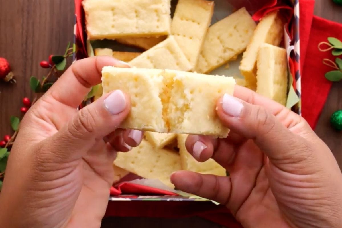 Shortbread Cookies in gift box with hand breaking one
