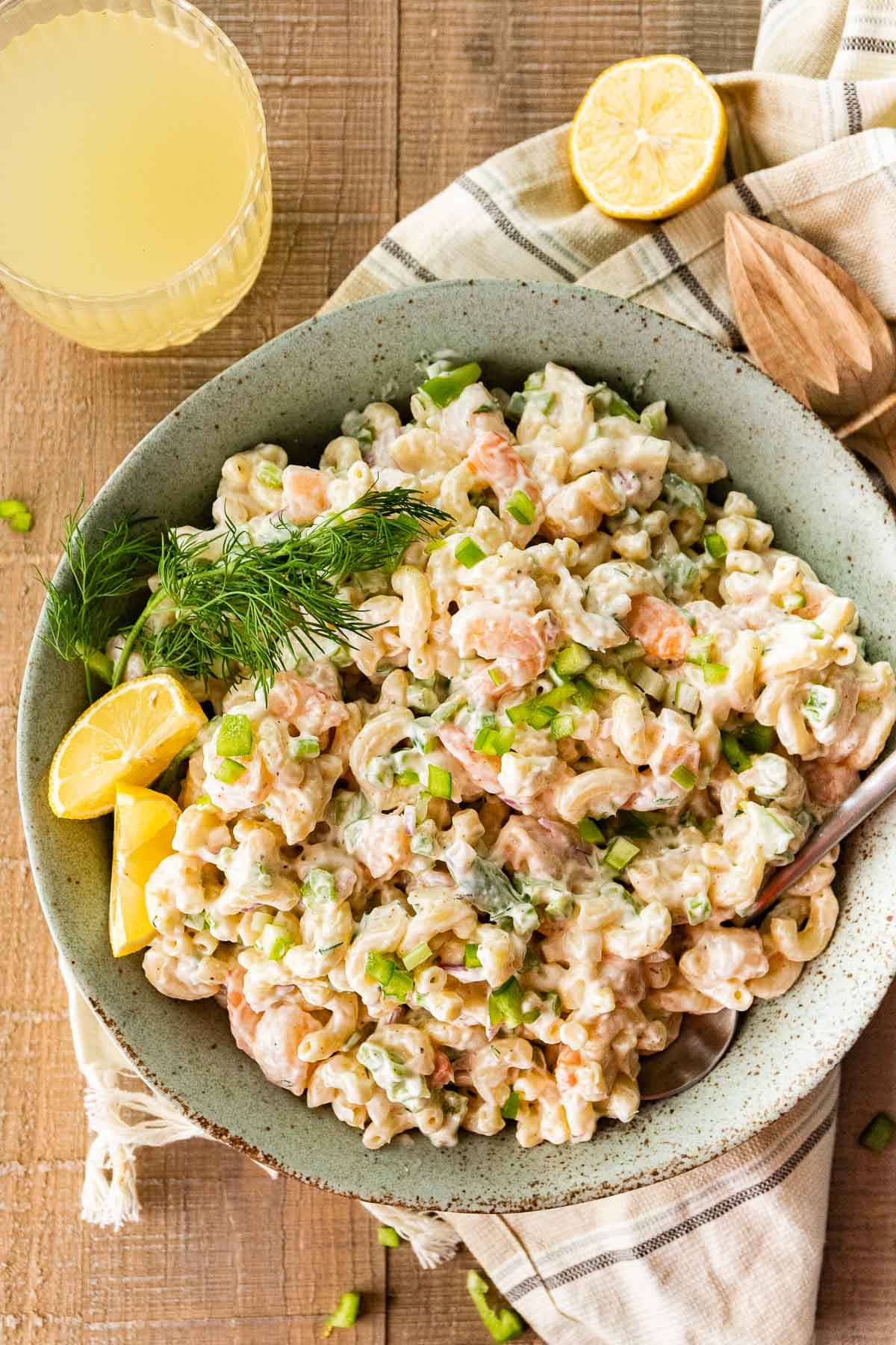 Creamy Shrimp Pasta Salad in serving bowl with fresh dill and lemon wedge garnish