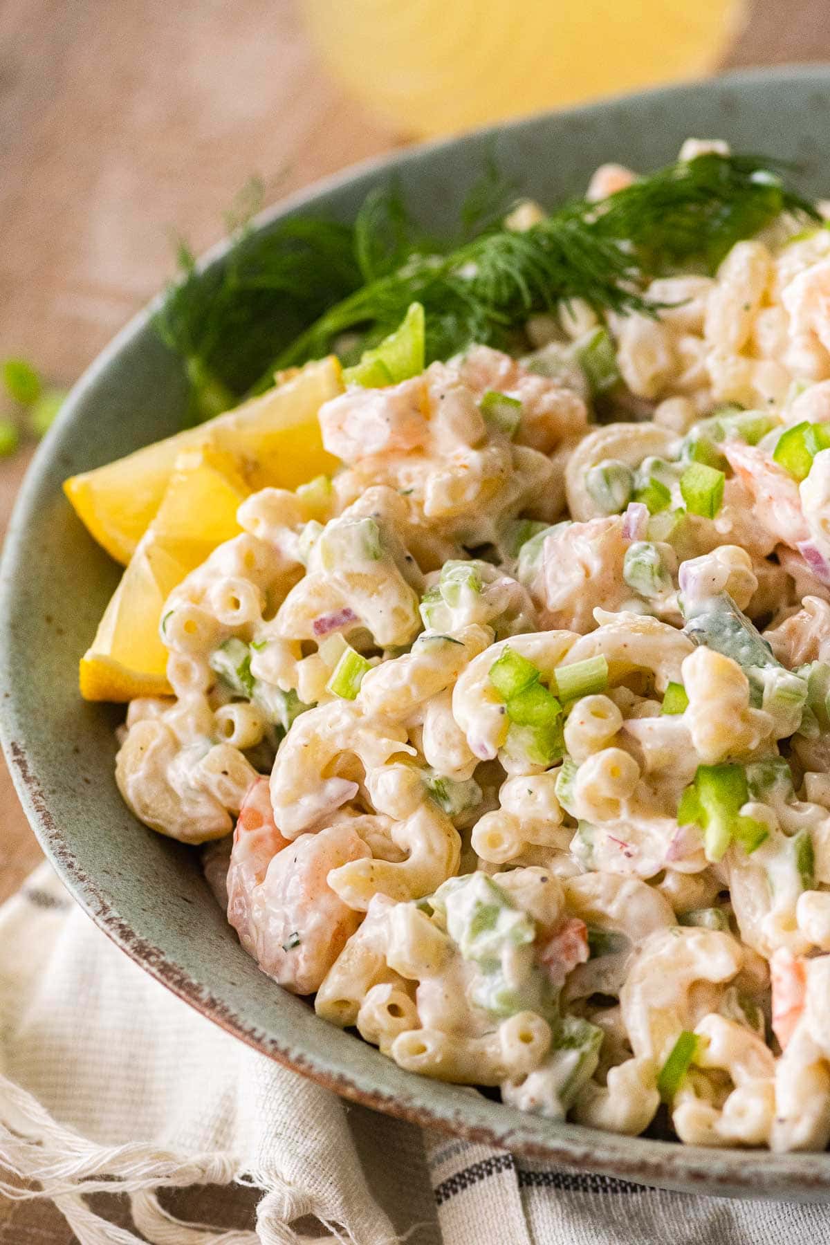 Creamy Shrimp Pasta Salad in serving bowl with fresh dill and lemon wedge garnish