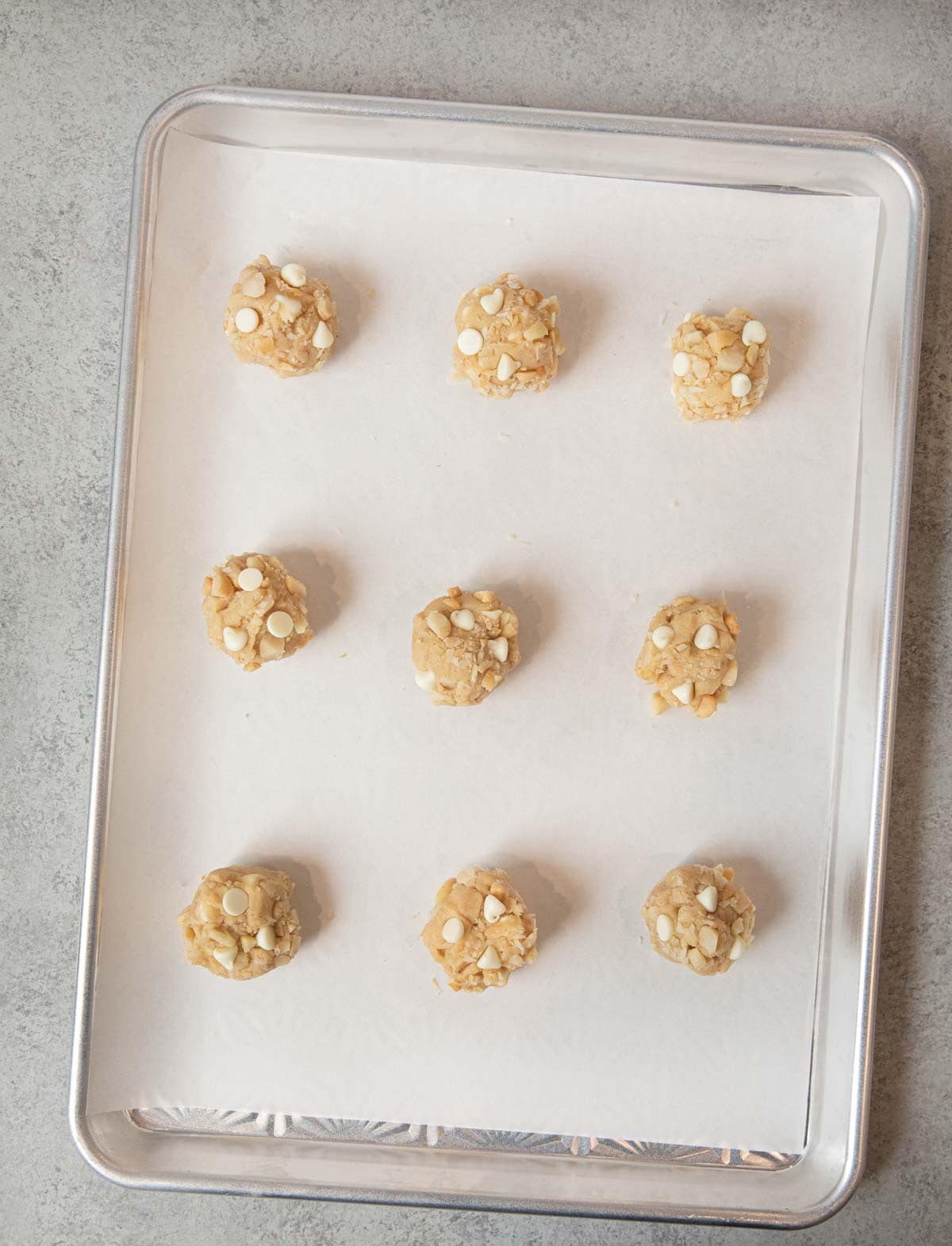 White Chocolate Macadamia Chip Cookies dough balls on baking sheet