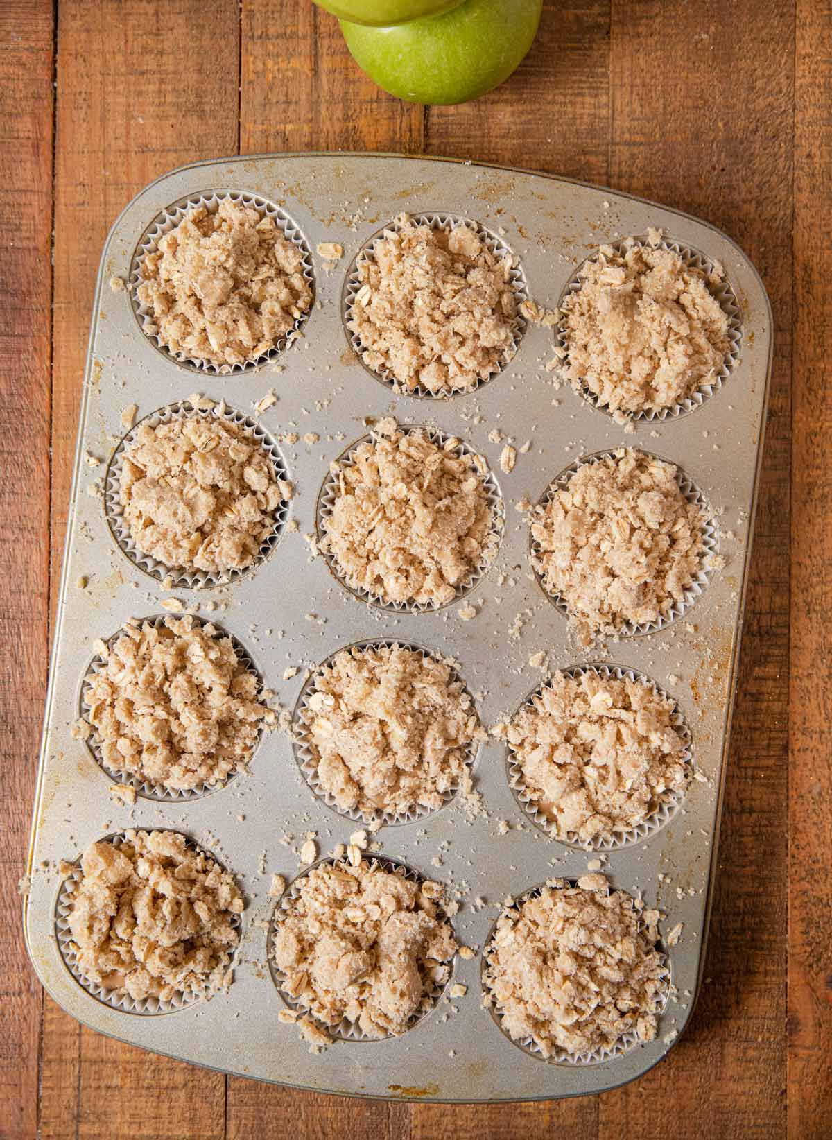 Apple Crisp Muffins batter and topping in cupcake tin