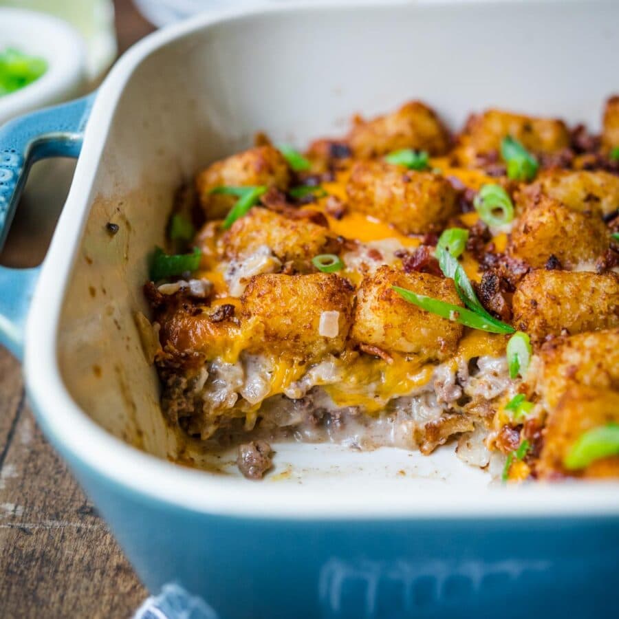 Finished Bacon Cheeseburger Tater Tot Casserole in 9x13 pan with bacon and green onions garnish