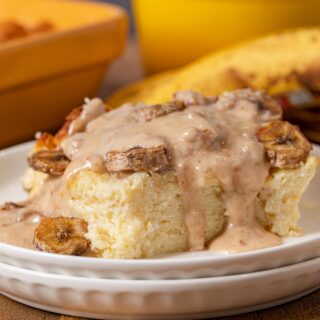 Banana Bread Pudding serving on plate with pecan vanilla sauce