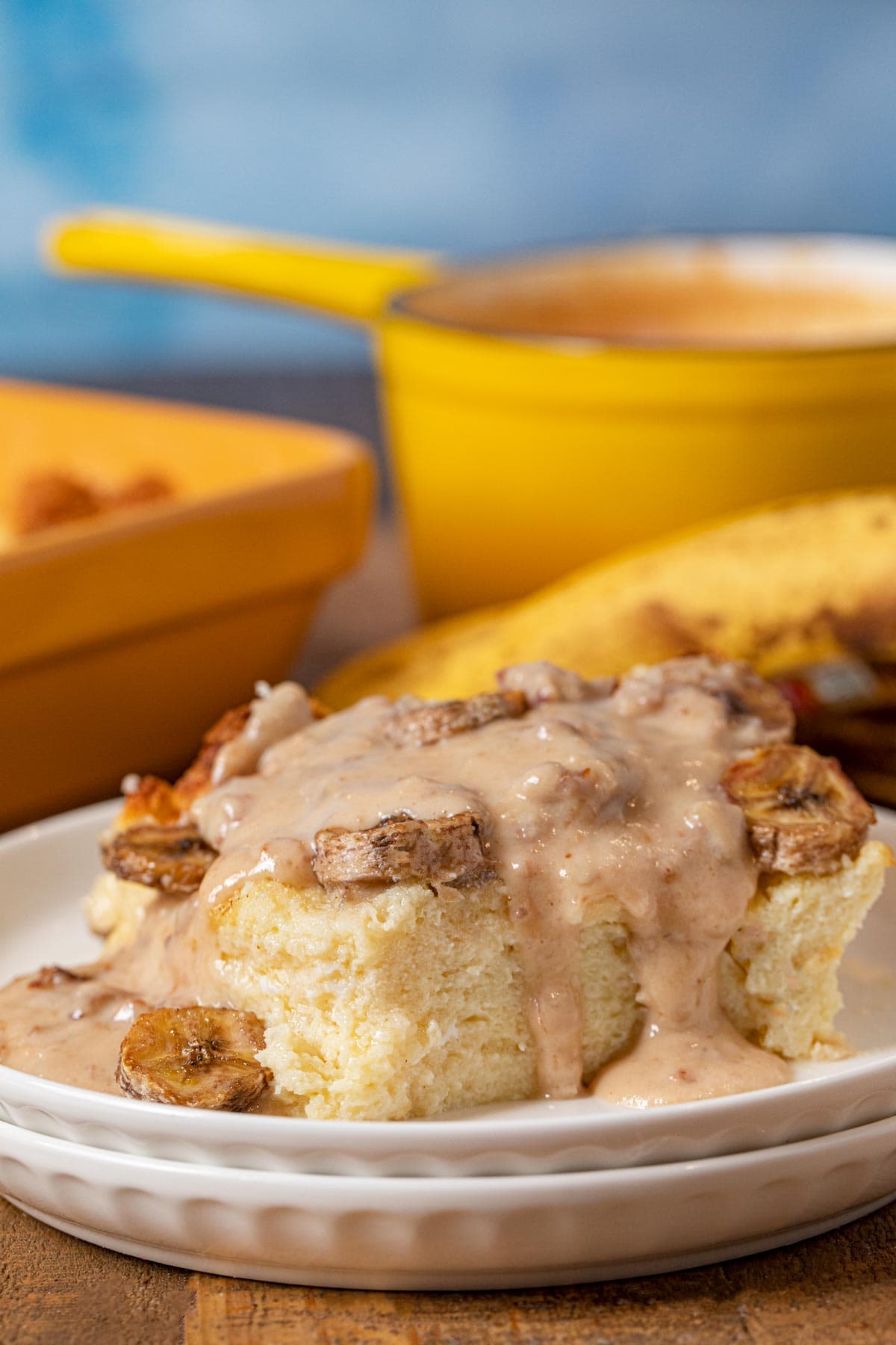 Banana Bread Pudding serving on plate with pecan vanilla sauce