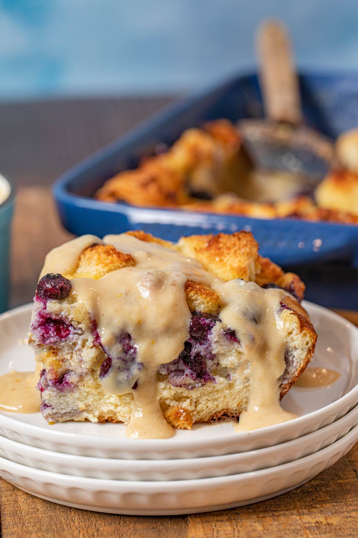 Blueberry Bread Pudding serving on plate with lemon-vanilla glaze