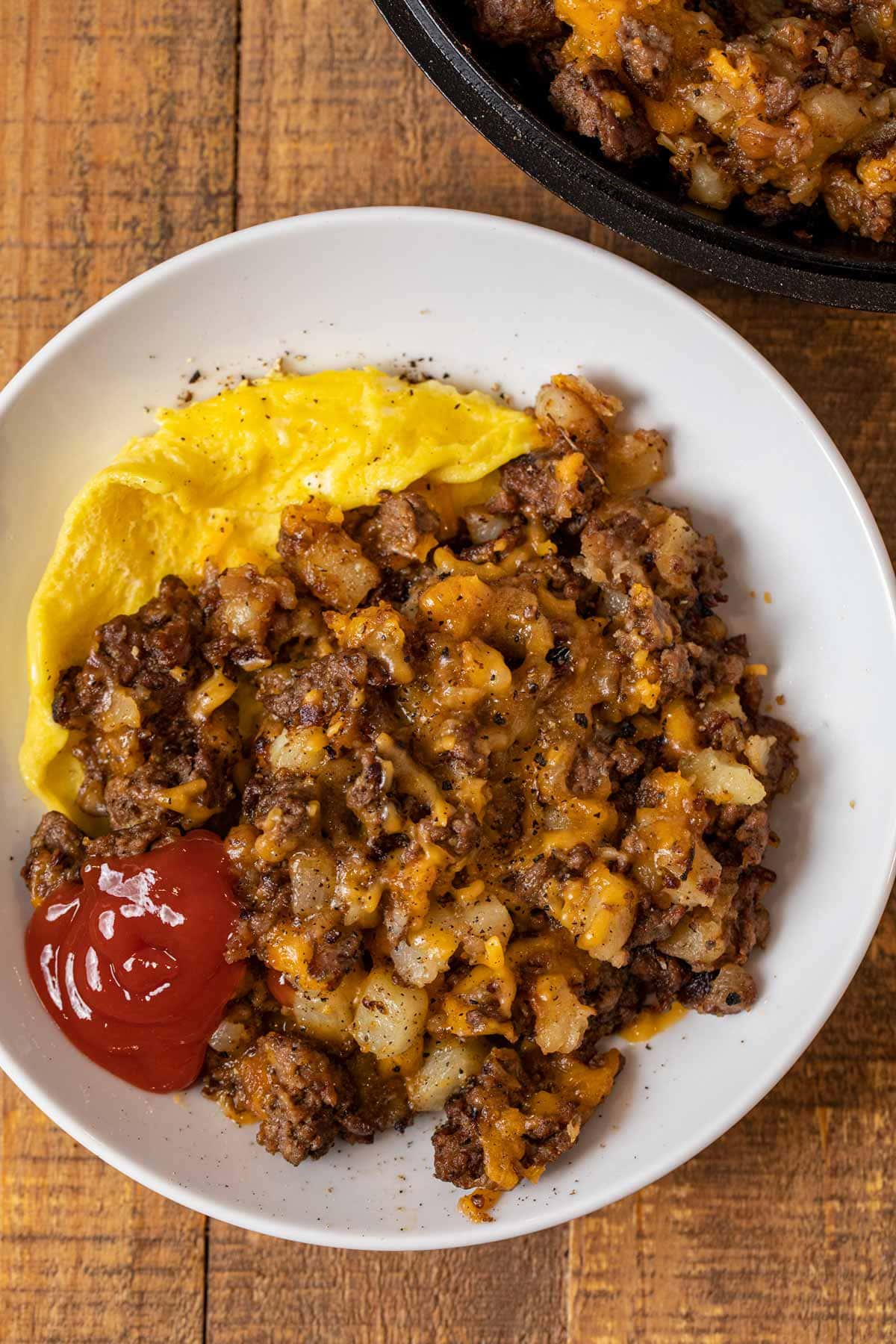 Cheesy Hamburger Hash on plate with egg