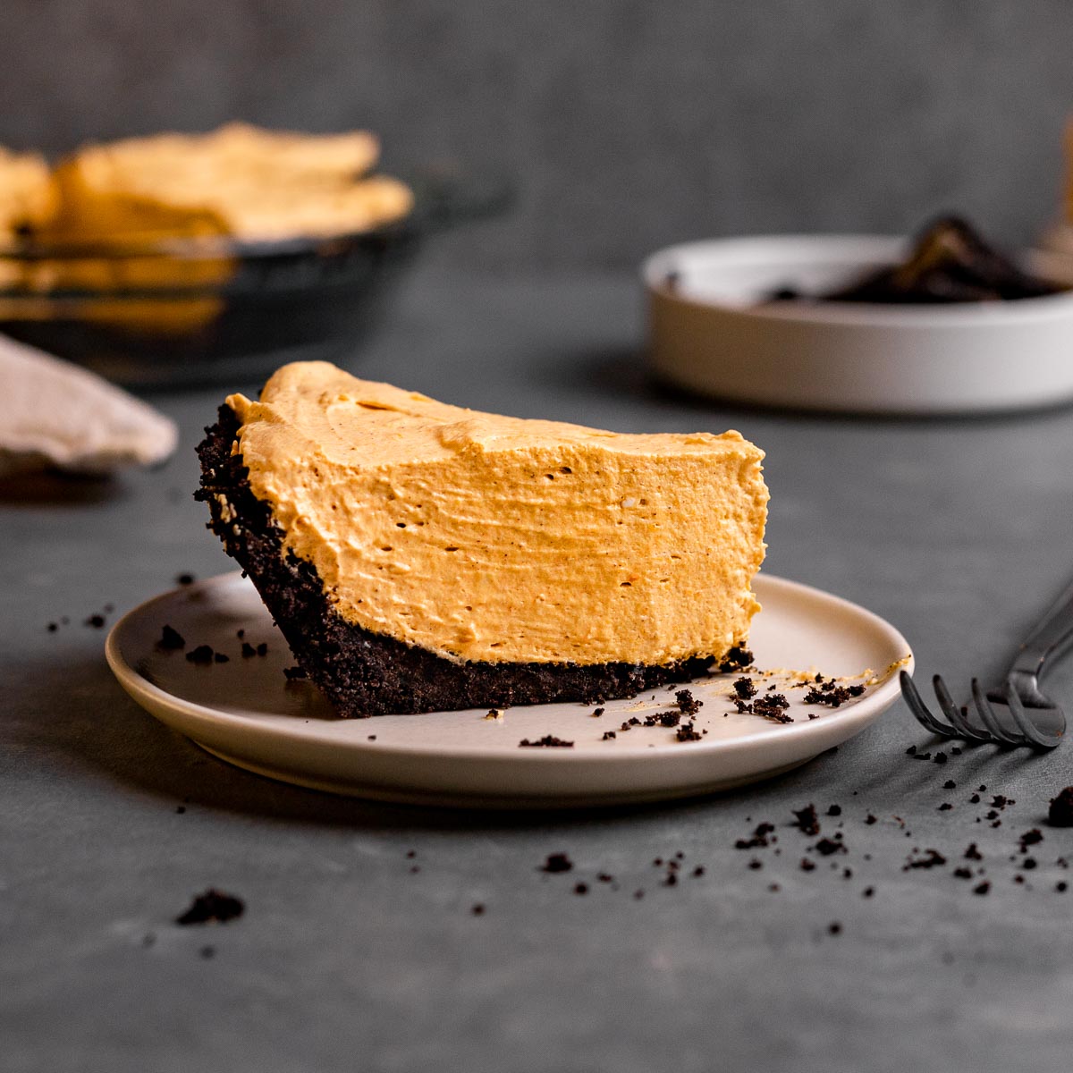 Chocolate Oreo Pumpkin Whip Pie slice on plate