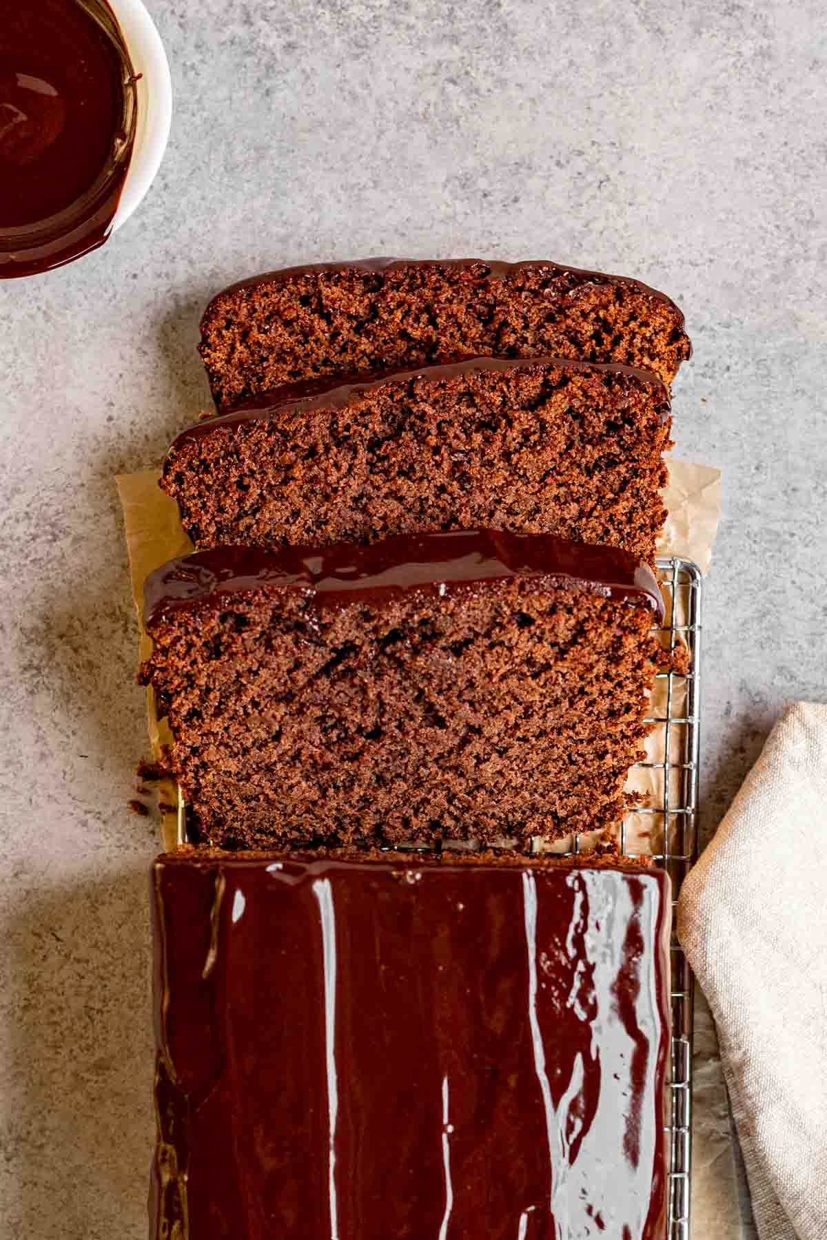 Chocolate Pound Cake with chocolate ganache sliced on parchment