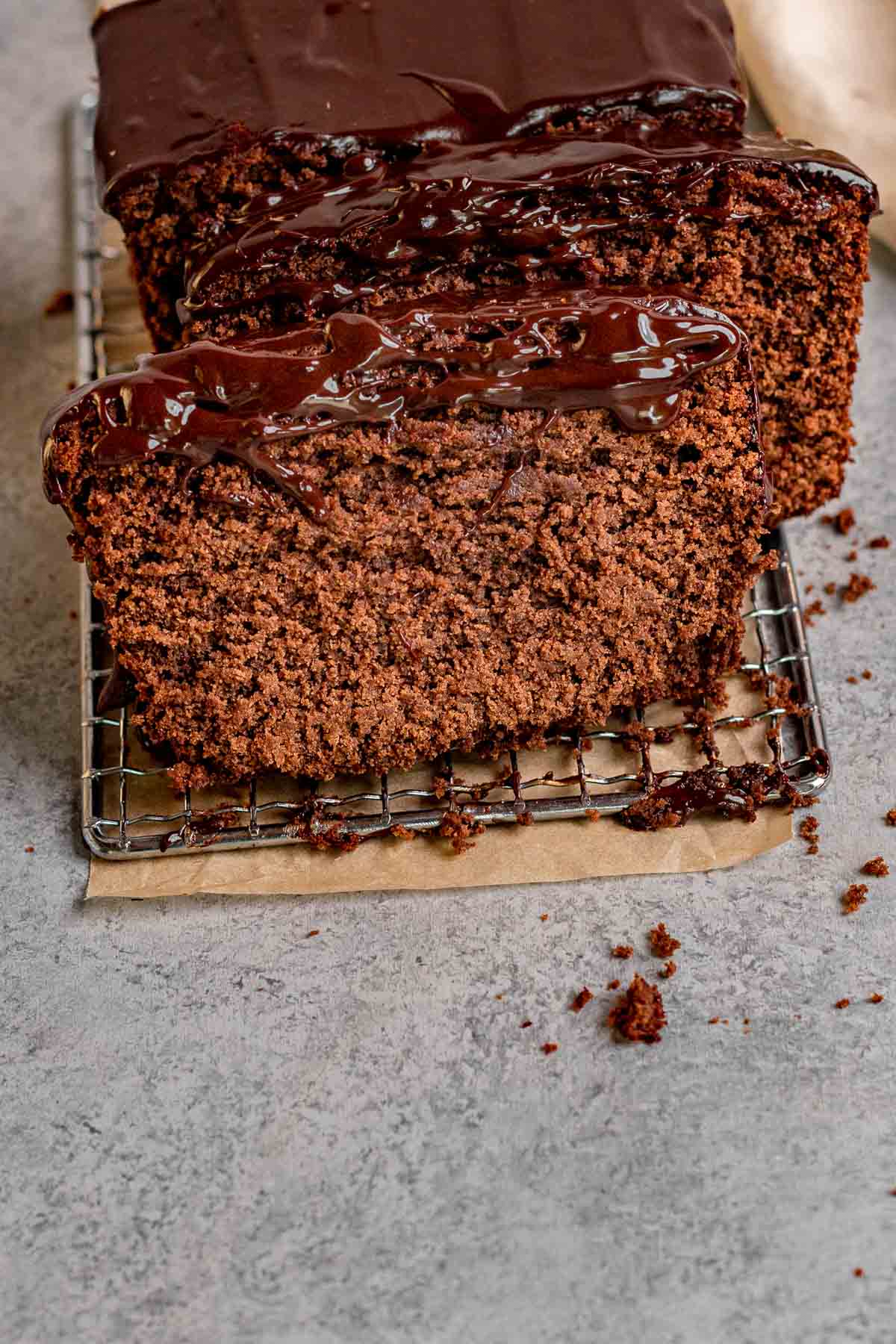 Chocolate Pound Cake with chocolate ganache sliced on parchment