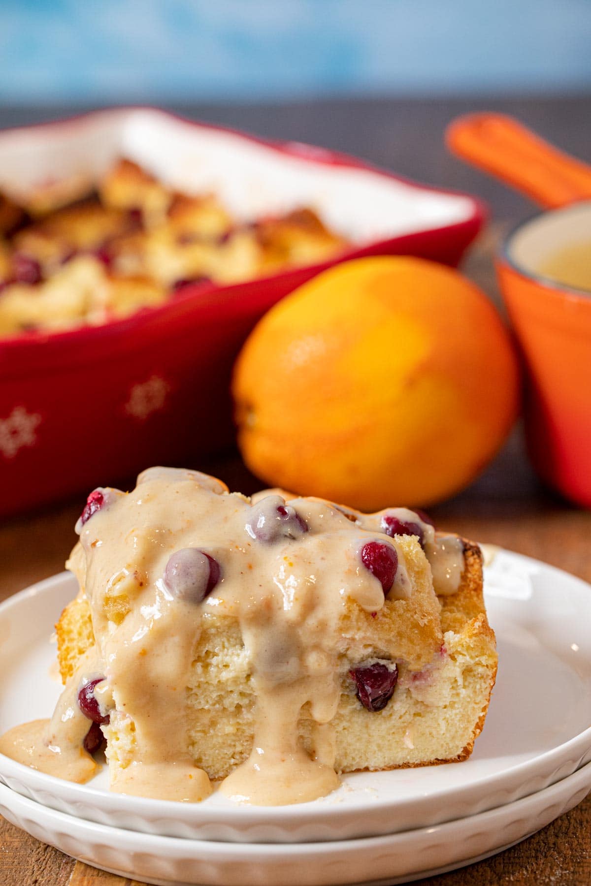 Cranberry Bread Pudding serving on plate with orange vanilla sauce