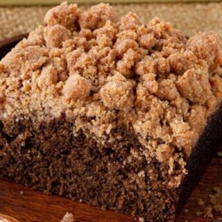 A piece of Crumb Cake on a plate.