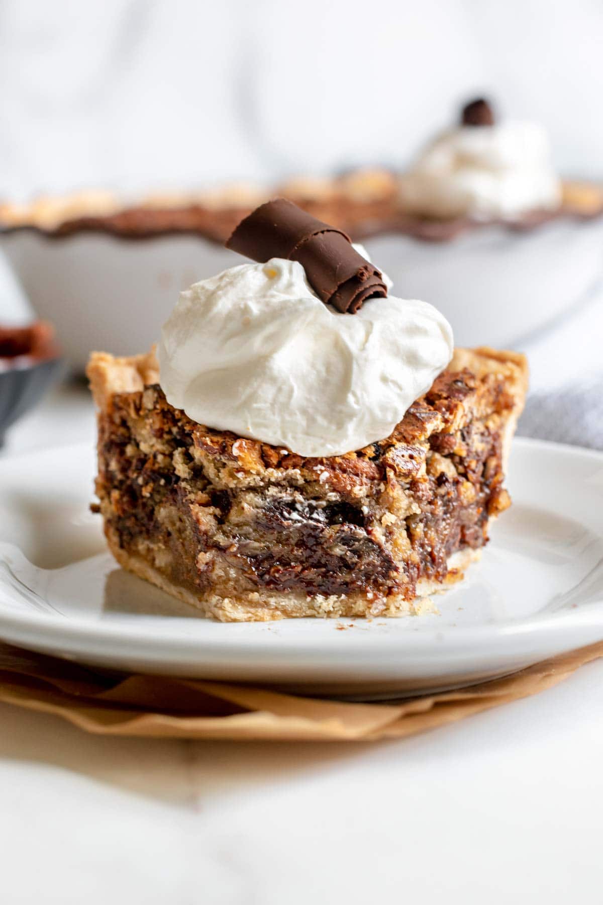 Kentucky Derby Pie slice on plate with whipped cream