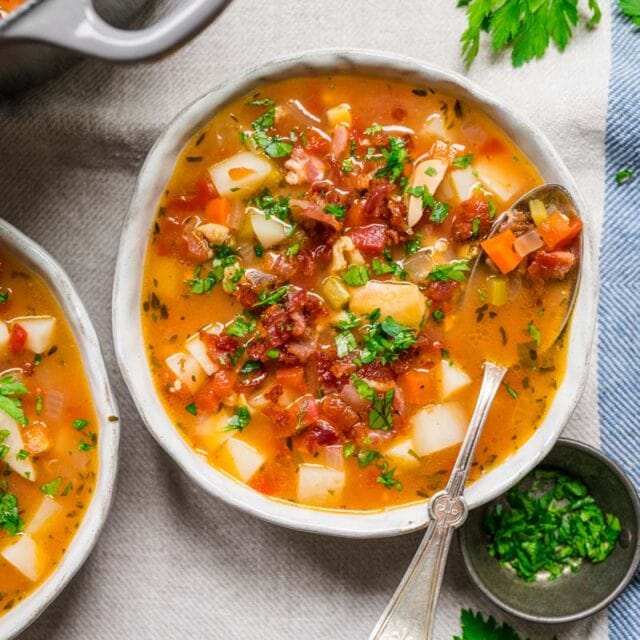 Chowder in bowl with bacon and parsley garnish