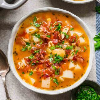 Chowder in bowl with bacon and parsley garnish
