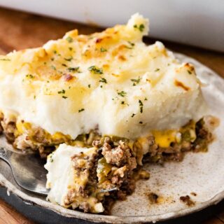fluffy melty topping on top of seasoned ground meat on a plate