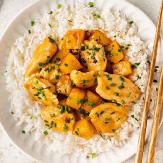 Pineapple chicken atop a bed of rice.