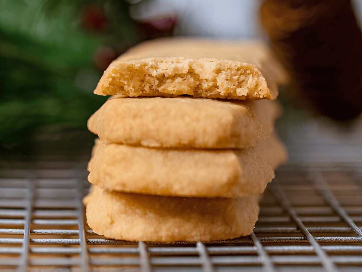 stacked buttery cookies with the top one bitten