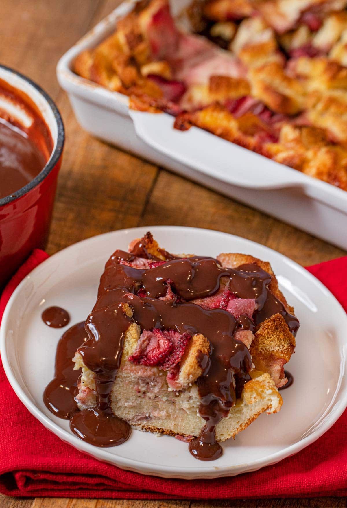 Strawberry Nutella Bread Pudding serving on plate with Nutella sauce