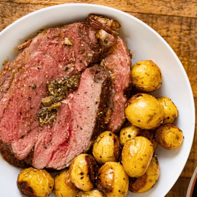 Slice of lamb on plate with potatoes