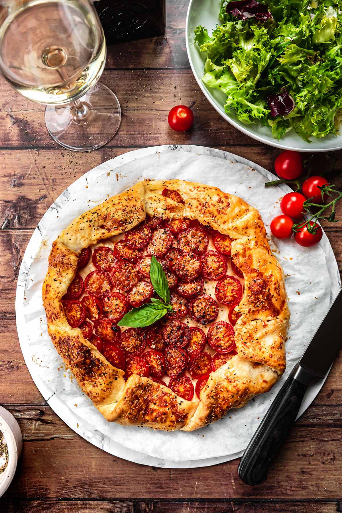 Tomato Goat Cheese Galette on plate with fresh basil garnish