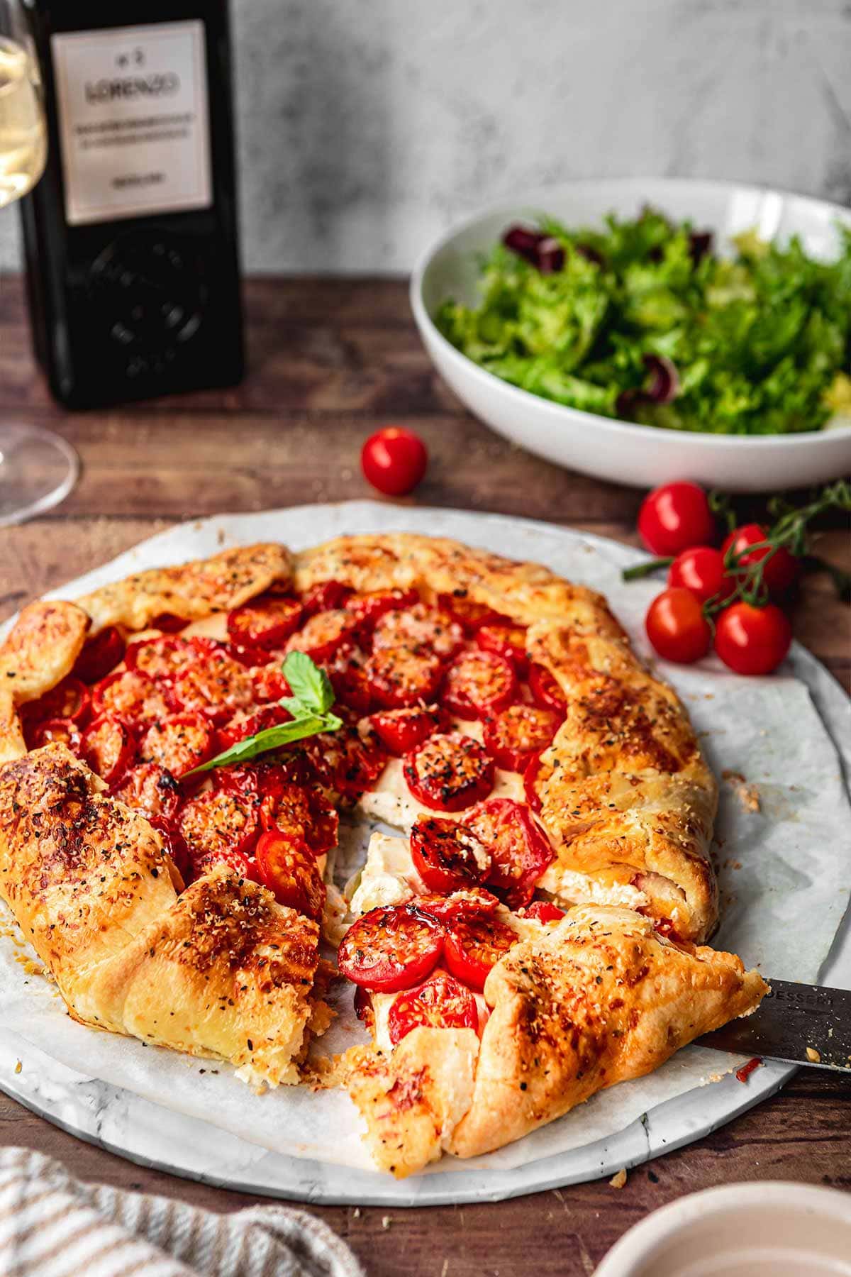 Tomato Goat Cheese Galette on plate with fresh basil garnish