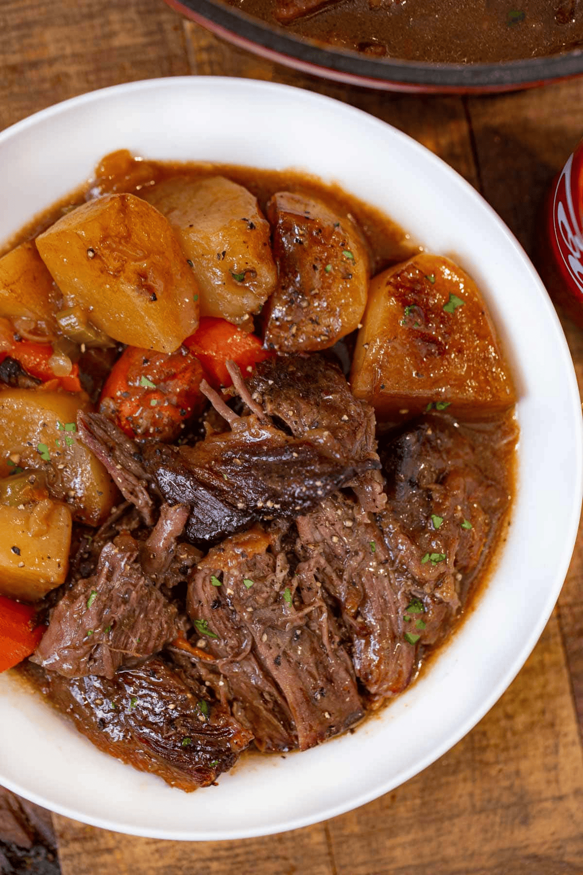 served pot roast in a white bowl
