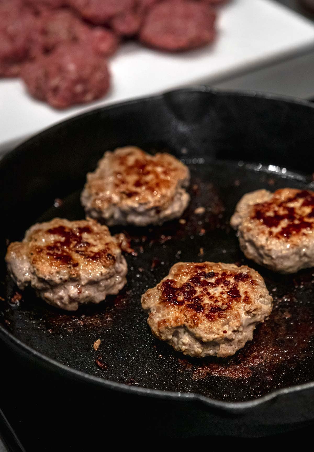 Breakfast Pork Sausage patties in cast iron skillet