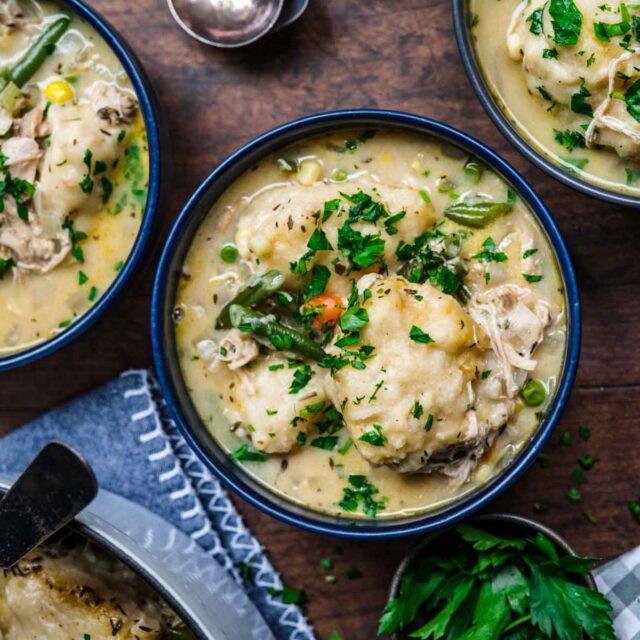 Chicken and Dumplings Soup in bowl with parsley garnish